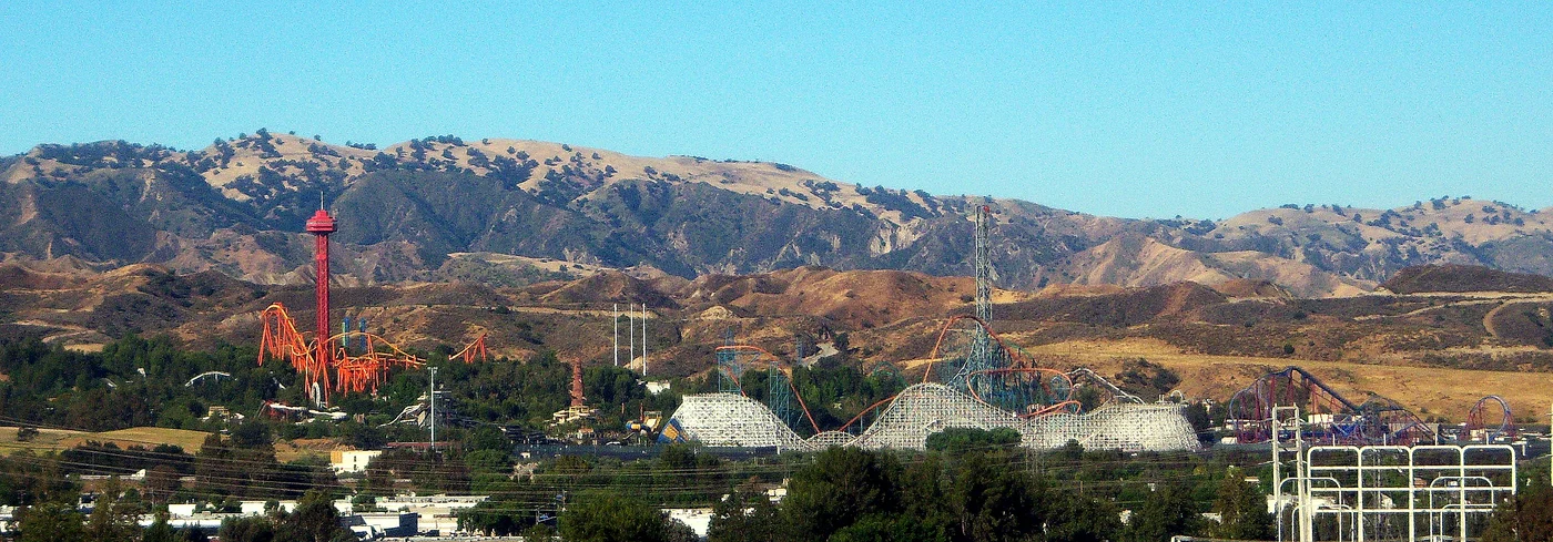 Historic panorama of Magic Mountain roller-coaster tracks against the hills
