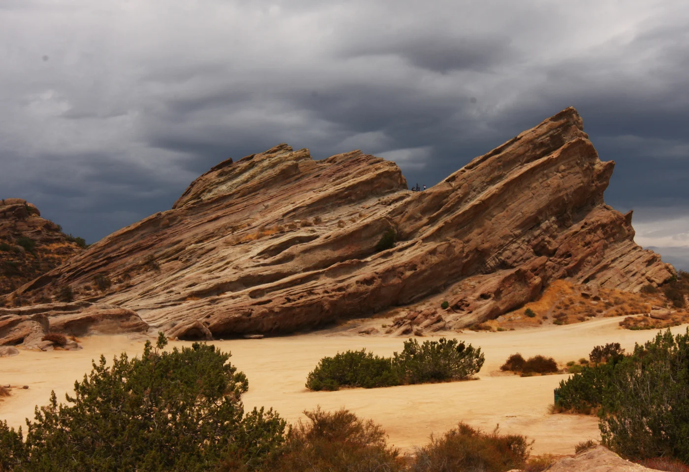 Angled sandstone formations at Vasquez Rocks beneath a cloudy sky